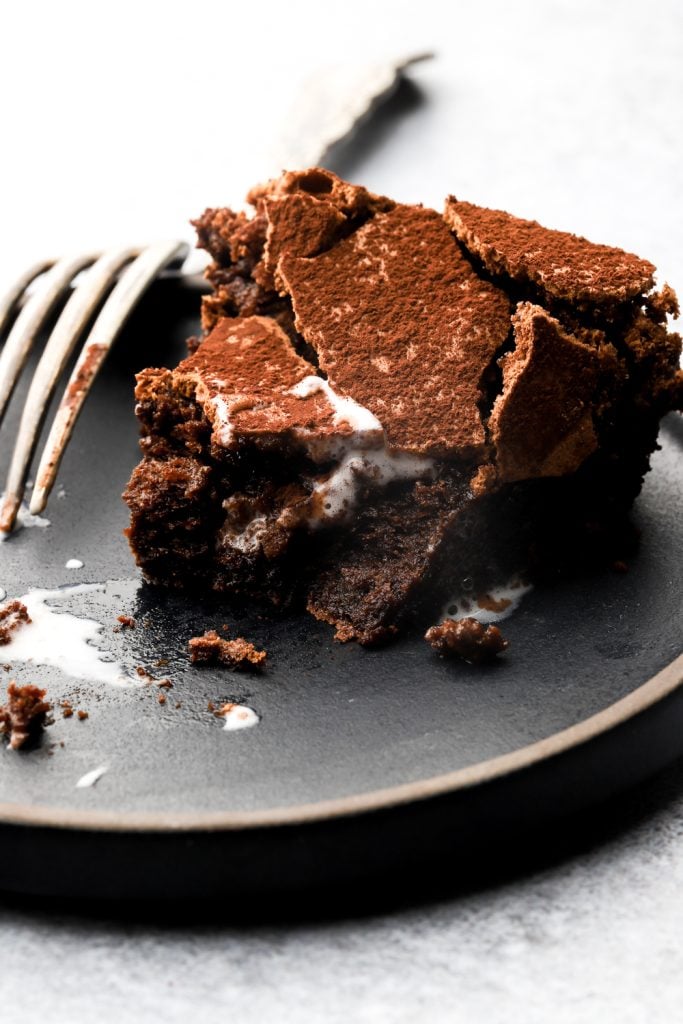 slice of torta tenerina on a plate with a bite taken out