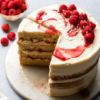white chocolate raspberry cake with a slice taken out