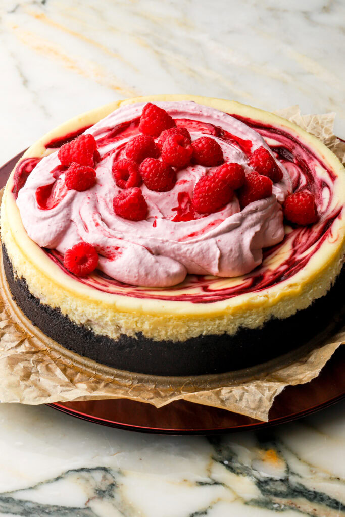 cheesecake topped with raspberry whipped cream