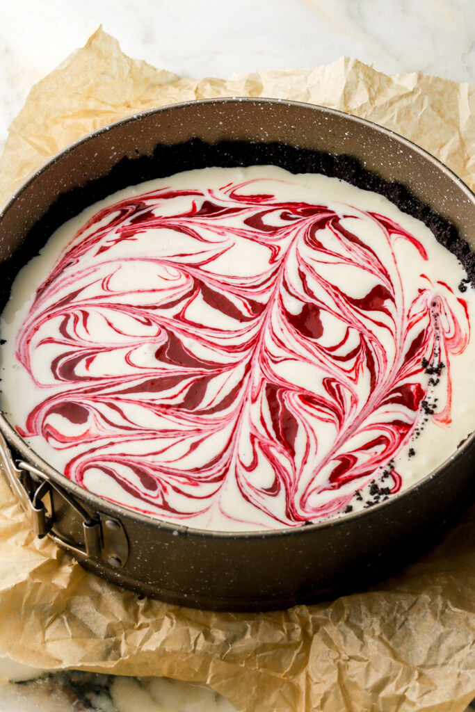 half of cheesecake poured over crust and swirled with raspberry filling