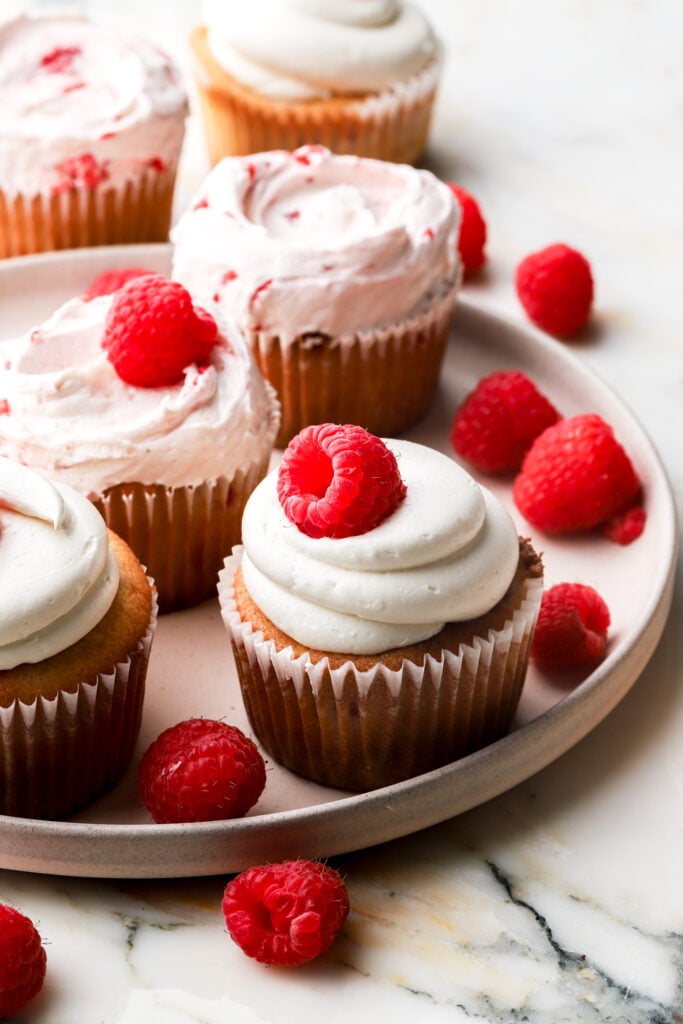 white chocolate raspberry cupcakes frosted with white buttercream