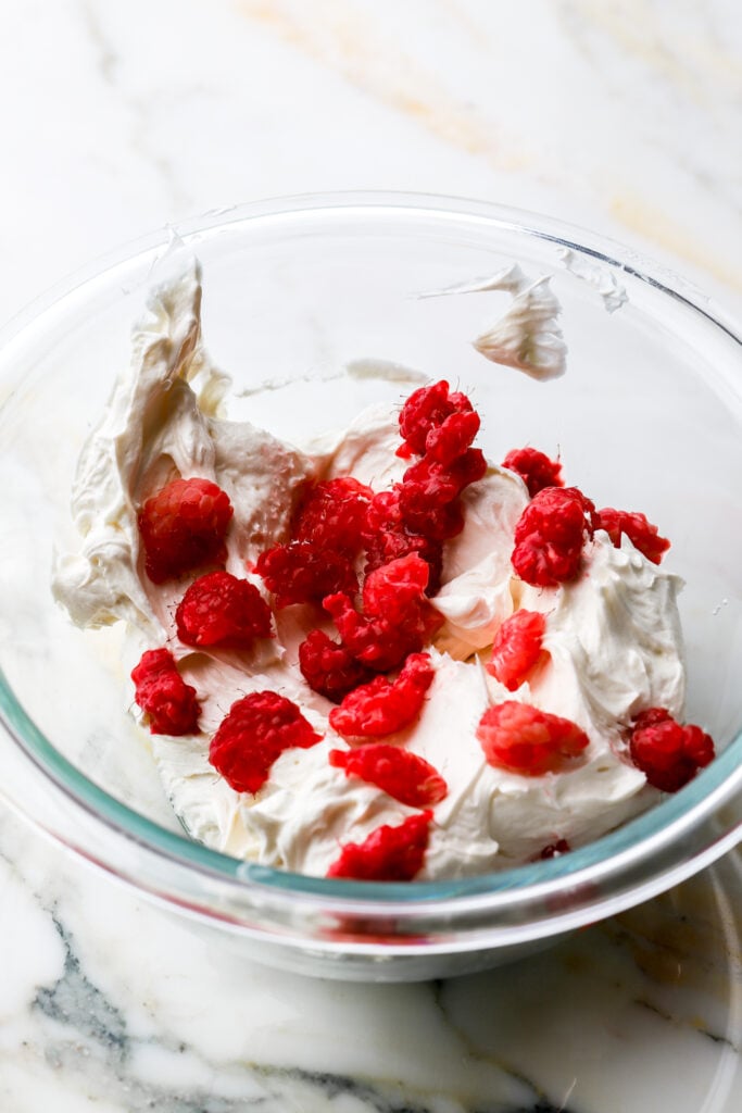 chopped raspberries added into half of the buttercream 