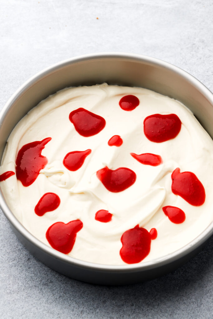globs of raspberry sauce on ice cream